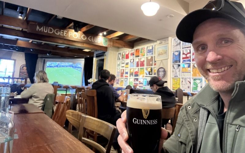 A man enjoying a beer inside a warm welcoming Kelly's Irish Pub in Mudgee, New South Wales.
