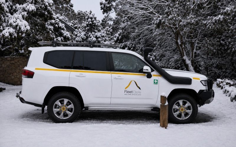 LandCruiser 300 Series parked in the snow with ski racks